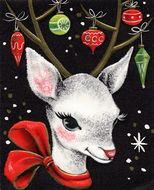 Chalk drawing of a white reindeer with green and red ornaments hanging from his antlers and a red bow around his neck against a black, snowflake-studded background.
